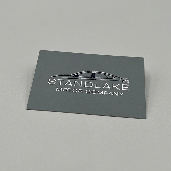 Spot UV business cards with selective gloss coating to highlight logos and key design elements.