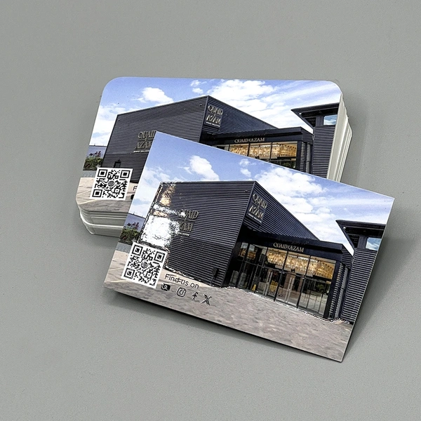 Spot UV business cards with selective gloss coating to highlight logos and key design elements.