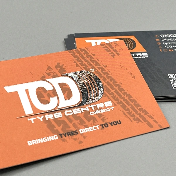 Spot UV business cards with selective gloss coating to highlight logos and key design elements.
