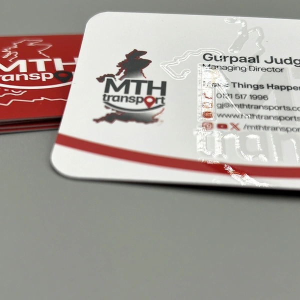 Spot UV rounded corner business cards with selective gloss coating to highlight logos and key design elements.